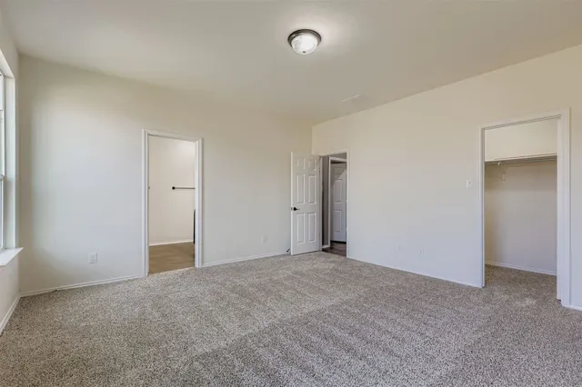 a view of an empty room and closet area