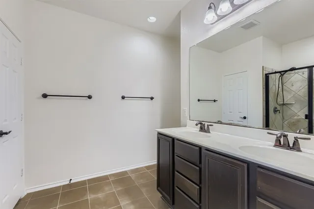 a bathroom with a sink vanity and a mirror