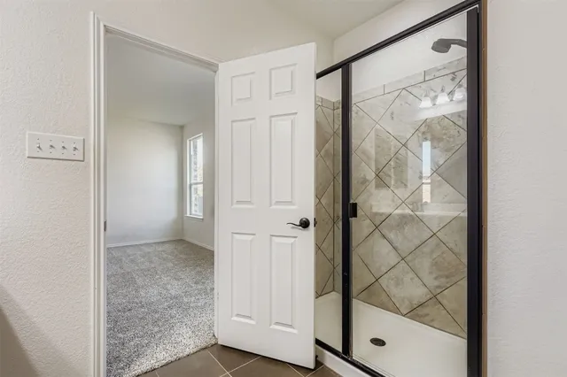 a bathroom with a glass shower door