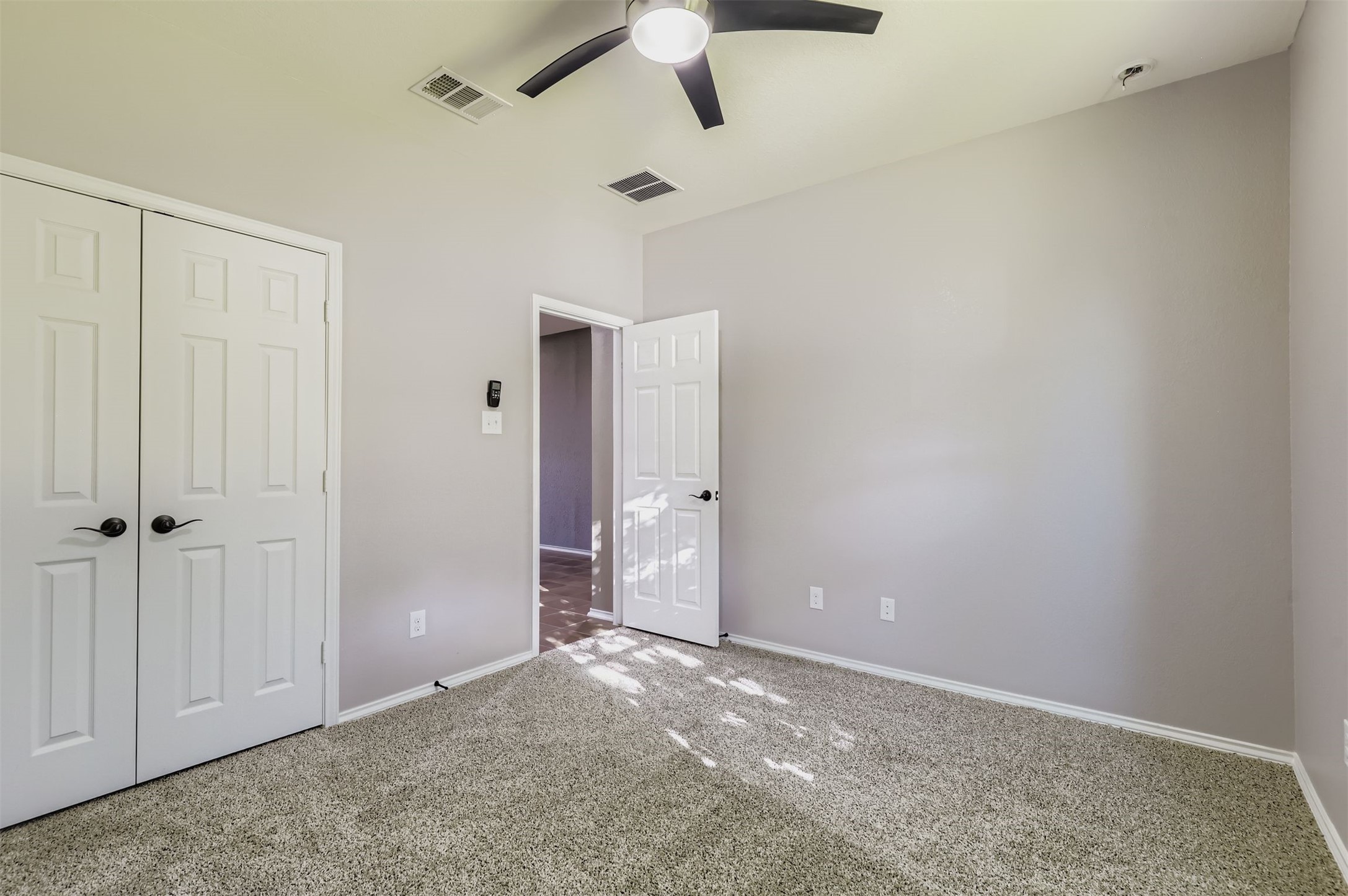 18808 Star Gazer Way Pflugerville, TX 78660 - Photo 17 of 27 Unfurnished bedroom featuring carpet floors, a closet, and ceiling fan