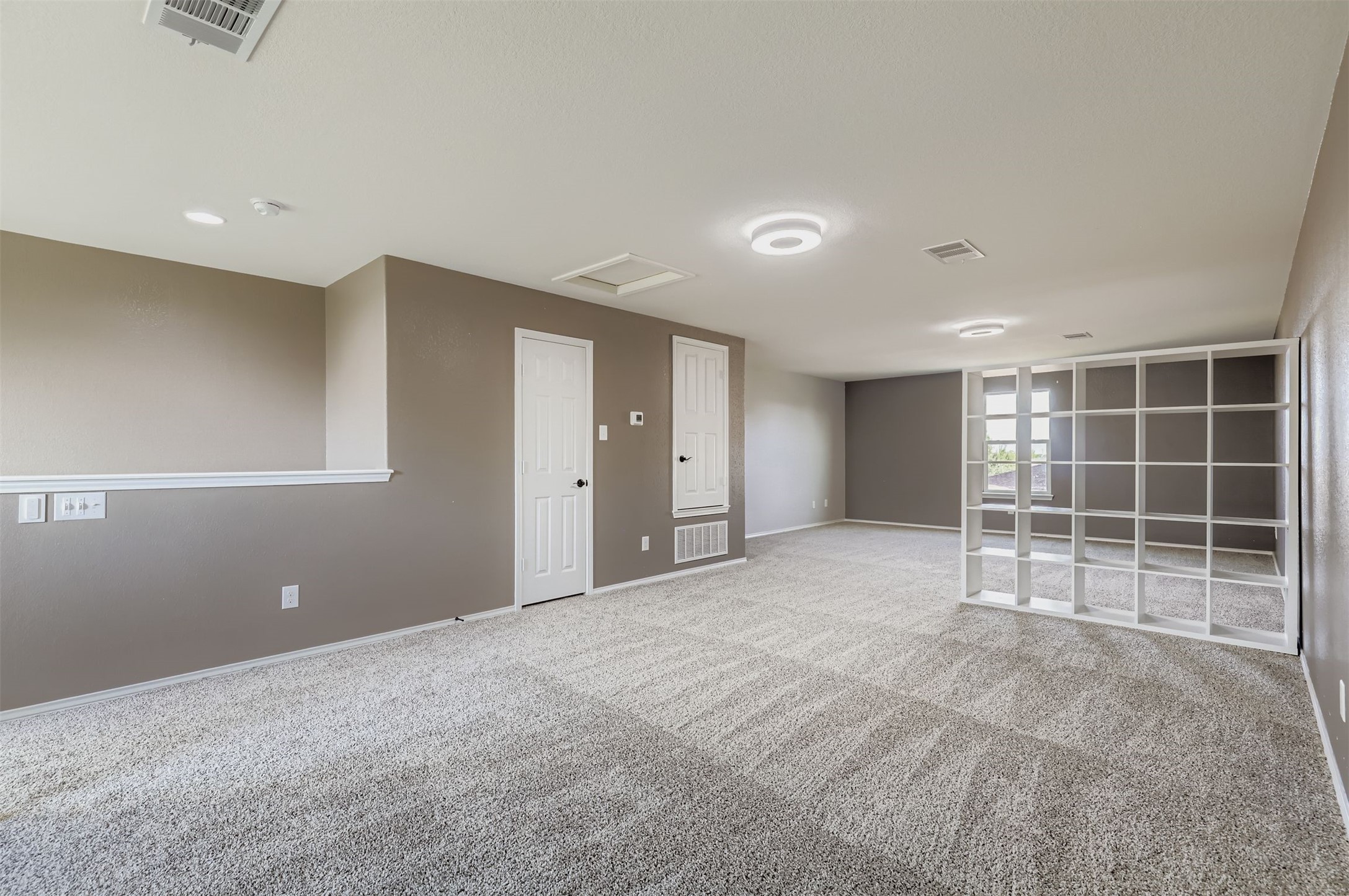 18808 Star Gazer Way Pflugerville, TX 78660 - Photo 22 of 27 Empty room with attic access and carpet flooring