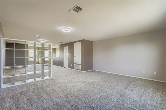 an empty room with a empty space and windows