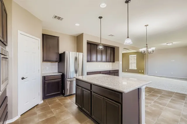 a kitchen with a refrigerator a sink and oven