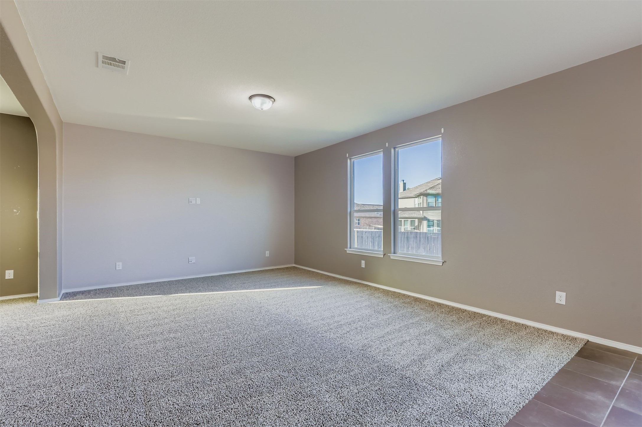18808 Star Gazer Way Pflugerville, TX 78660 - Photo 7 of 27 Empty room featuring arched walkways and baseboards