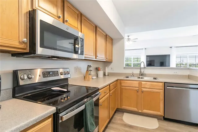 a kitchen with a sink stove and microwave
