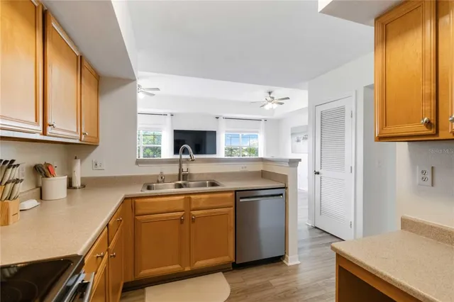 a kitchen with a sink stove and cabinets