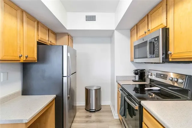 a kitchen with a stove and a refrigerator