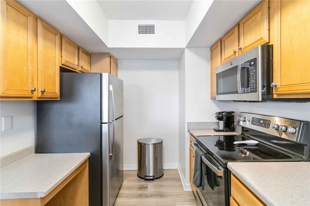 1050 Villagio Circle, Unit 206 Sarasota, FL 34237 - Photo 20 of 57 a kitchen with a stove and a refrigerator