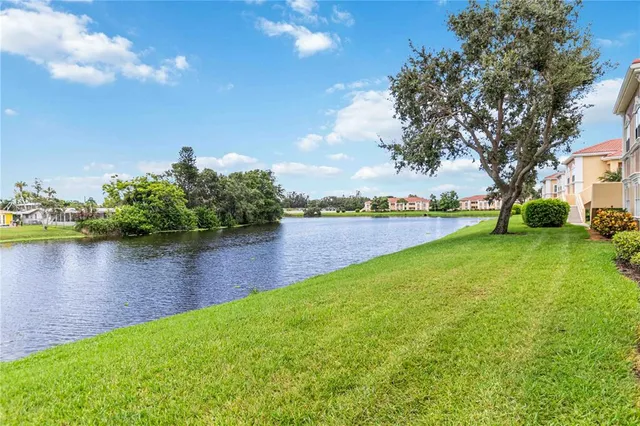 a view of a lake with houses in the back