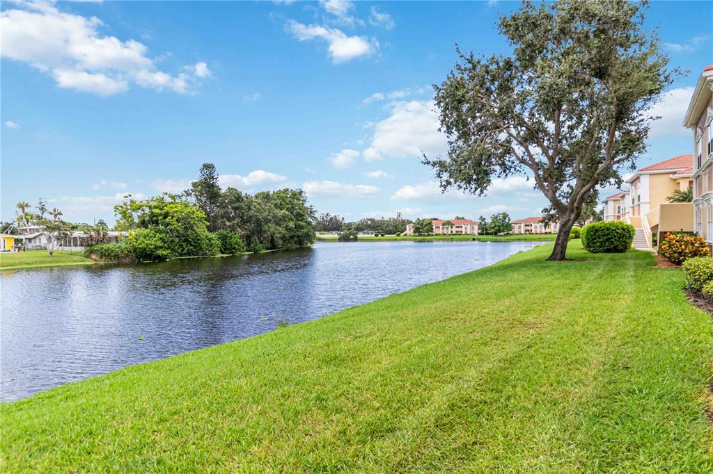 1050 Villagio Circle, Unit 206 Sarasota, FL 34237 - Photo 2 of 57 a view of a lake with houses in the back
