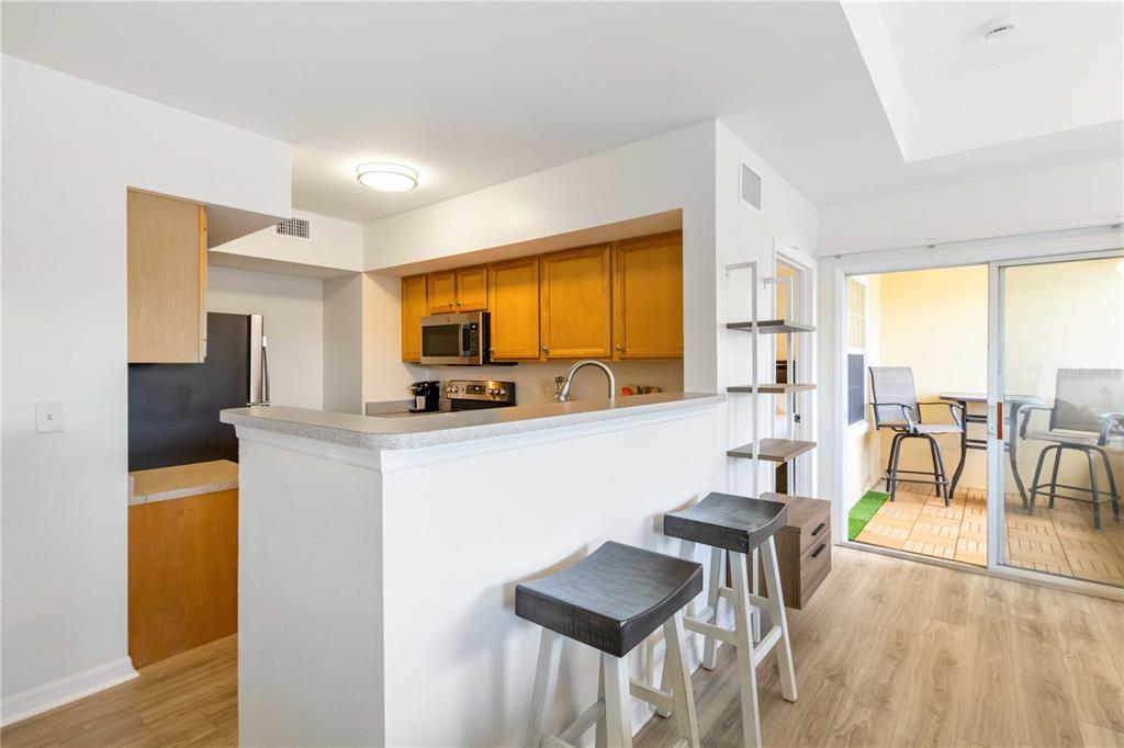 1050 Villagio Circle, Unit 206 Sarasota, FL 34237 - Photo 21 of 57 a living room with furniture a large window with kitchen view