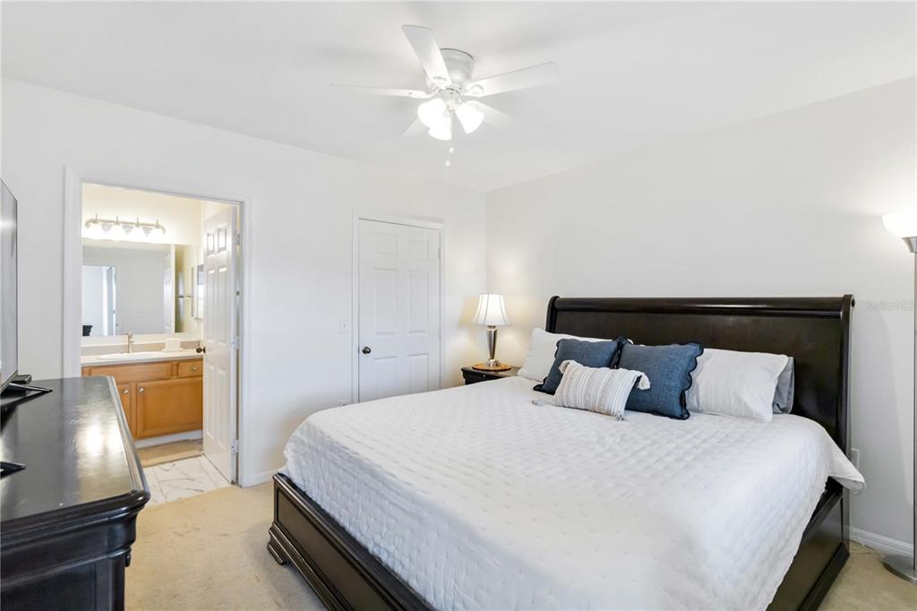 1050 Villagio Circle, Unit 206 Sarasota, FL 34237 - Photo 23 of 57 a bedroom with a bed and a chandelier