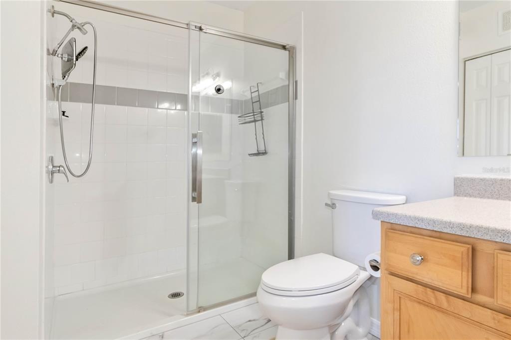 1050 Villagio Circle, Unit 206 Sarasota, FL 34237 - Photo 27 of 57 a bathroom with a shower a toilet and a sink