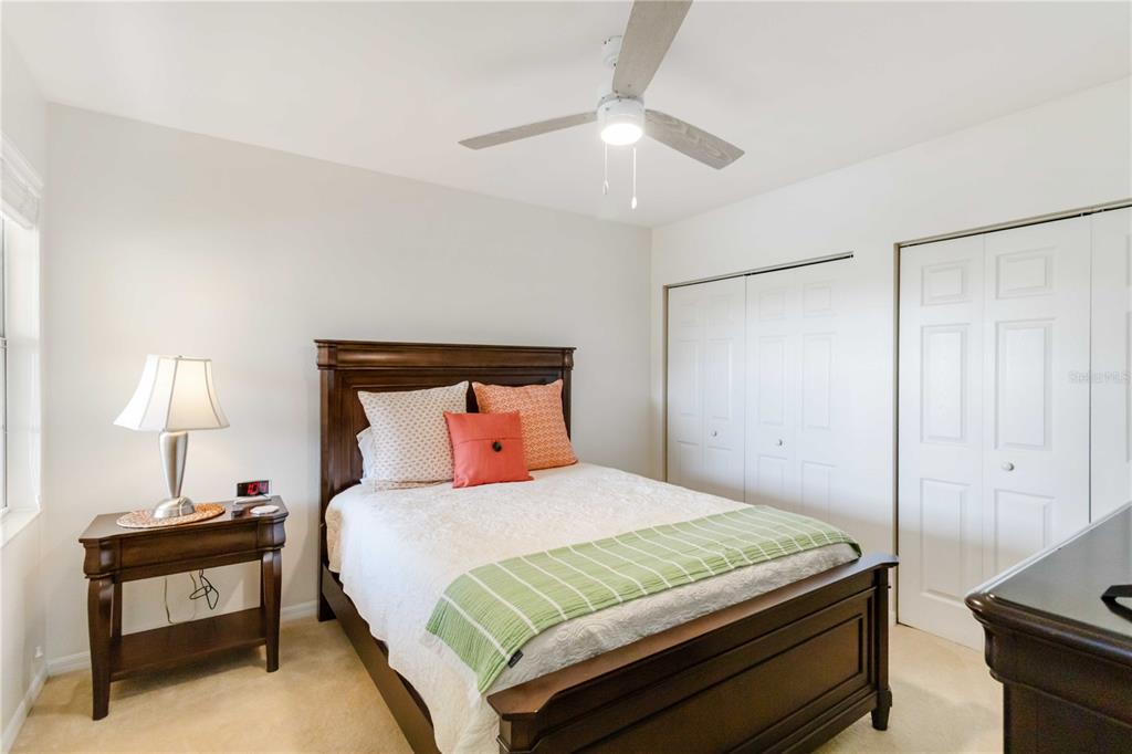 1050 Villagio Circle, Unit 206 Sarasota, FL 34237 - Photo 30 of 57 a bedroom with a bed and a lamp