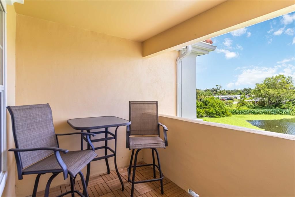 1050 Villagio Circle, Unit 206 Sarasota, FL 34237 - Photo 35 of 57 a balcony view with a outdoor seating space