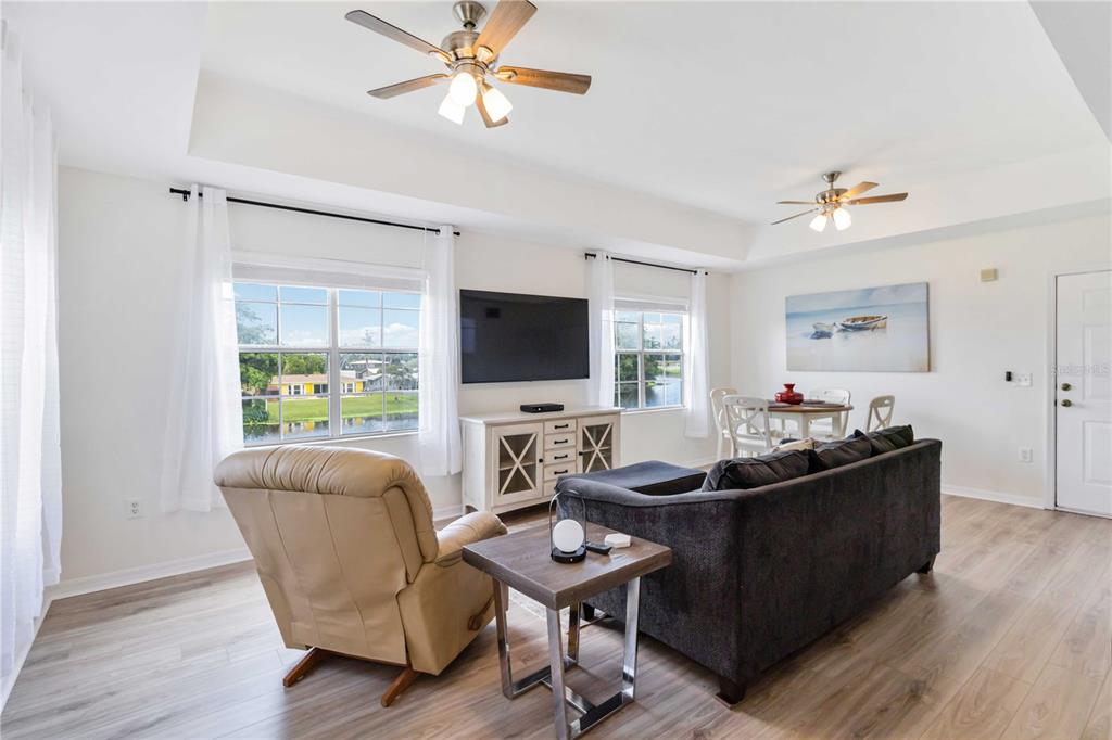 1050 Villagio Circle, Unit 206 Sarasota, FL 34237 - Photo 9 of 57 a living room with furniture a flat screen tv and a window