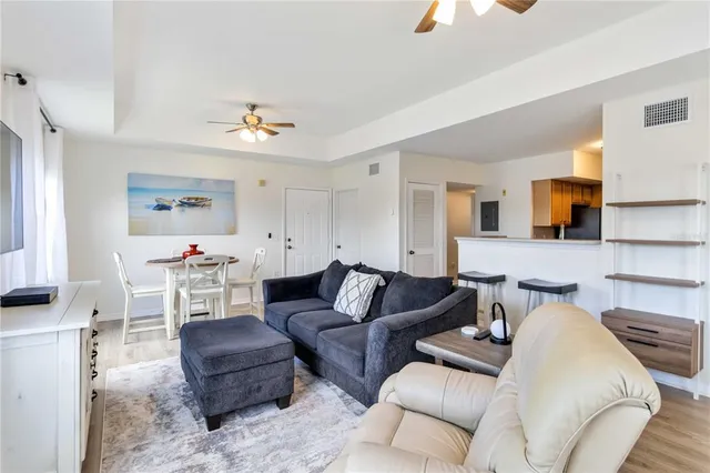 a living room with furniture and a lamp