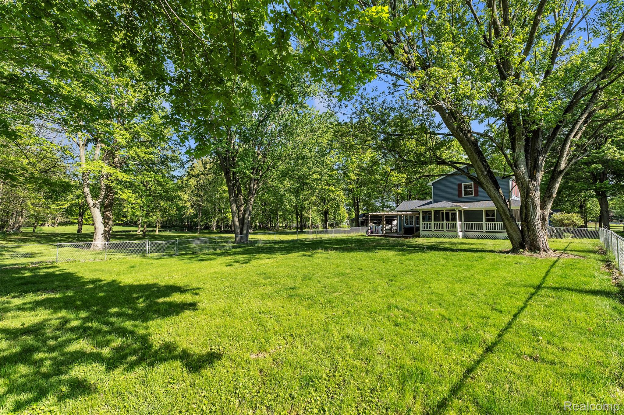 1345 Ives Road Mason, MI 48854 - Photo 71 of 92 Fenced backyard featuring view of wooded area