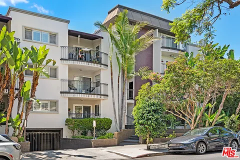 a front view of a house with a tree