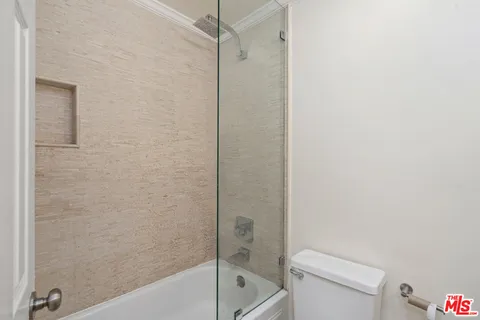 a bathroom with a toilet and a bathtub