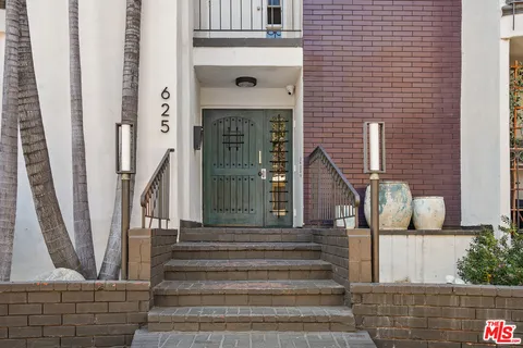 a front view of a house with entryway and stairs