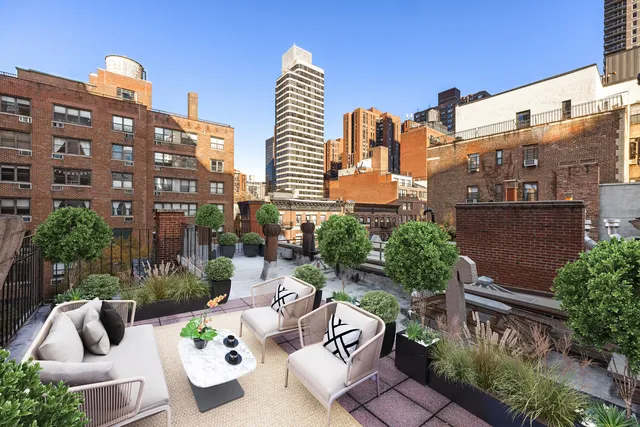 a view of a patio with a table and chairs