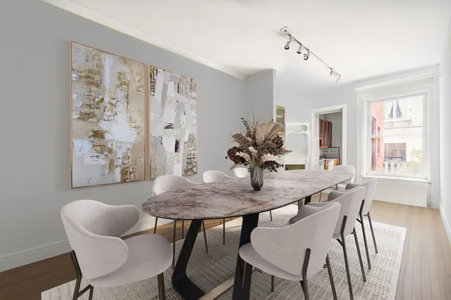 a living room with furniture a fireplace and a chandelier