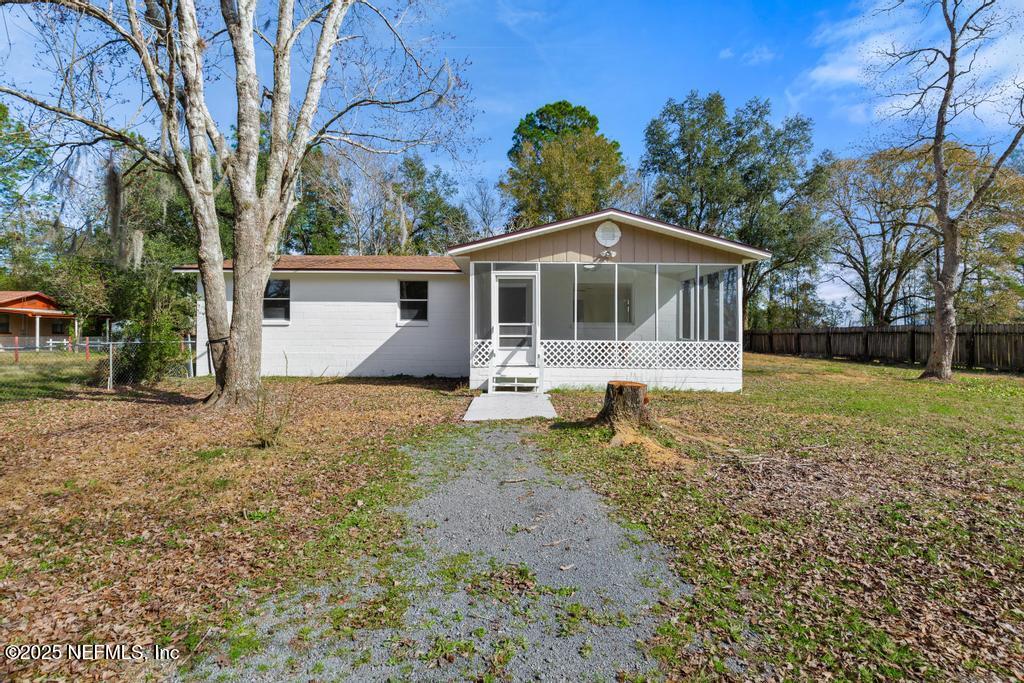 54074 Charles Street Callahan, FL 32011 - Photo 1 of 52 a front view of a house with garden