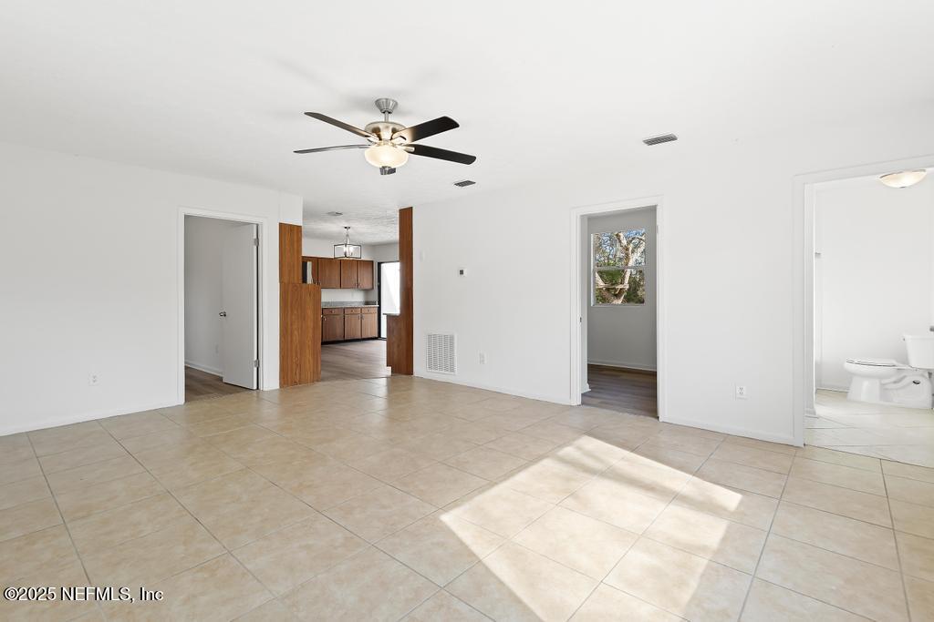 54074 Charles Street Callahan, FL 32011 - Photo 15 of 52 a view of a big room with closet and chandelier fan