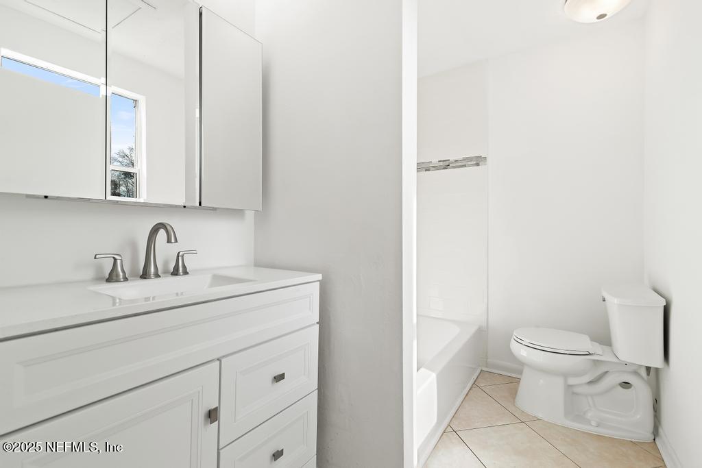54074 Charles Street Callahan, FL 32011 - Photo 18 of 52 a bathroom with a granite countertop sink mirror vanity and toilet