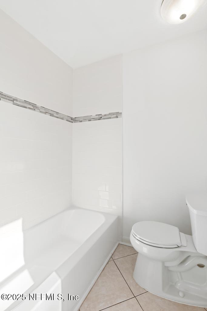 54074 Charles Street Callahan, FL 32011 - Photo 19 of 52 a white toilet sitting next to a bath tub