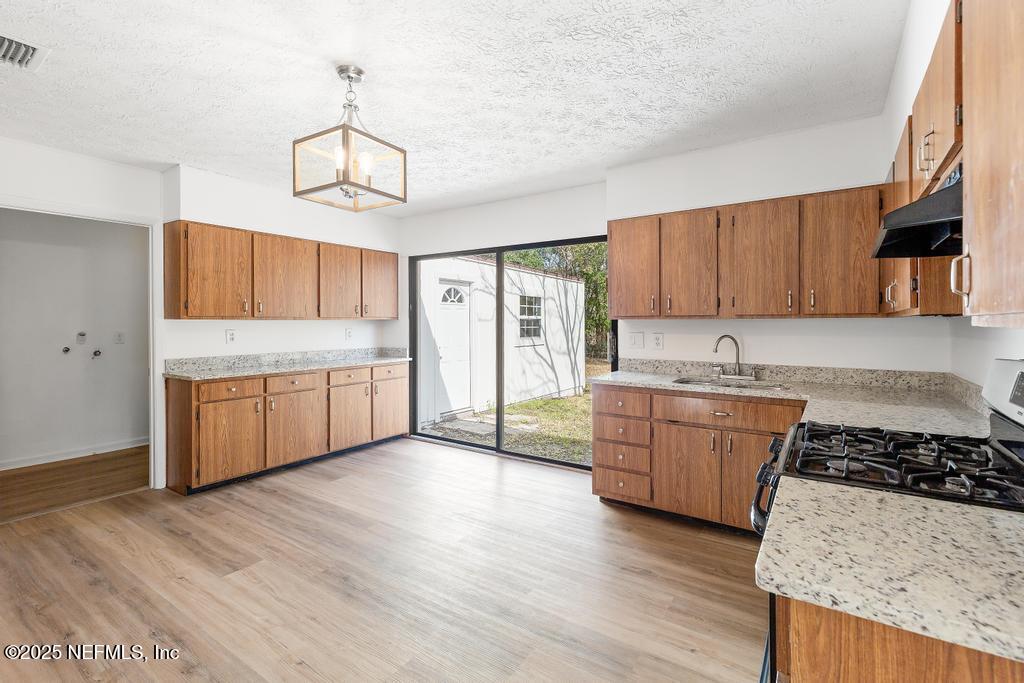 54074 Charles Street Callahan, FL 32011 - Photo 26 of 52 a large kitchen with a stove a sink and a refrigerator