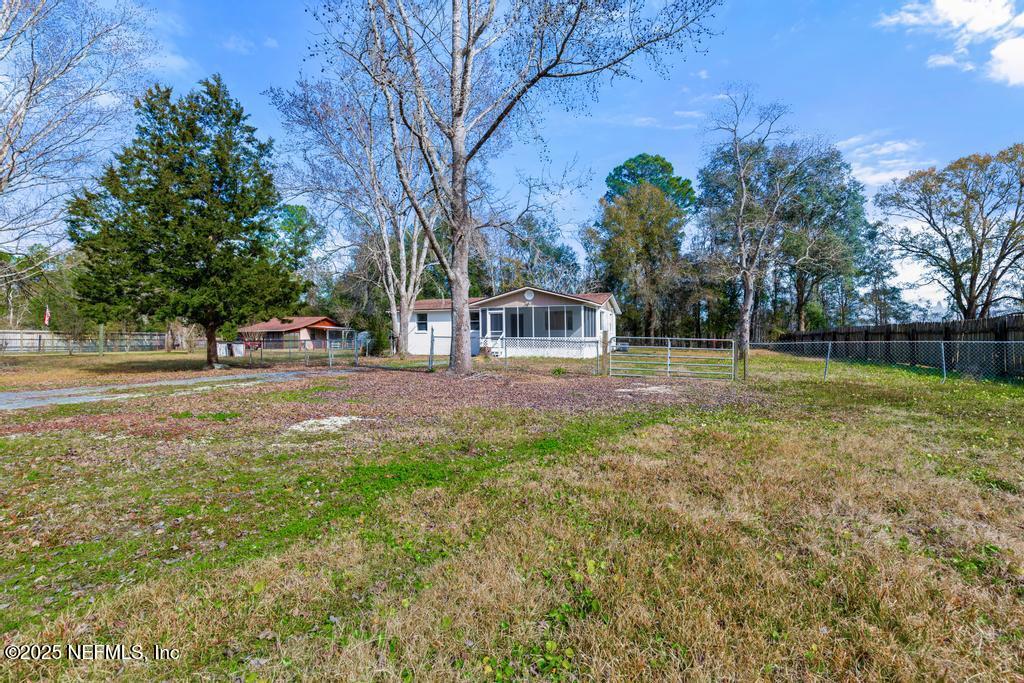 54074 Charles Street Callahan, FL 32011 - Photo 3 of 52 a backyard of a house with lots of green space and garden