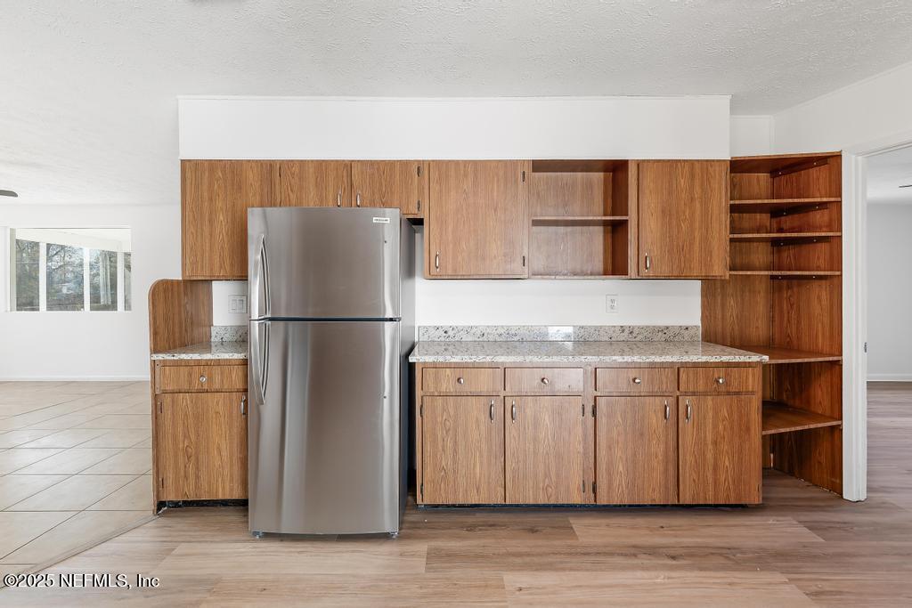 54074 Charles Street Callahan, FL 32011 - Photo 32 of 52 a kitchen with stainless steel appliances granite countertop a refrigerator and a sink