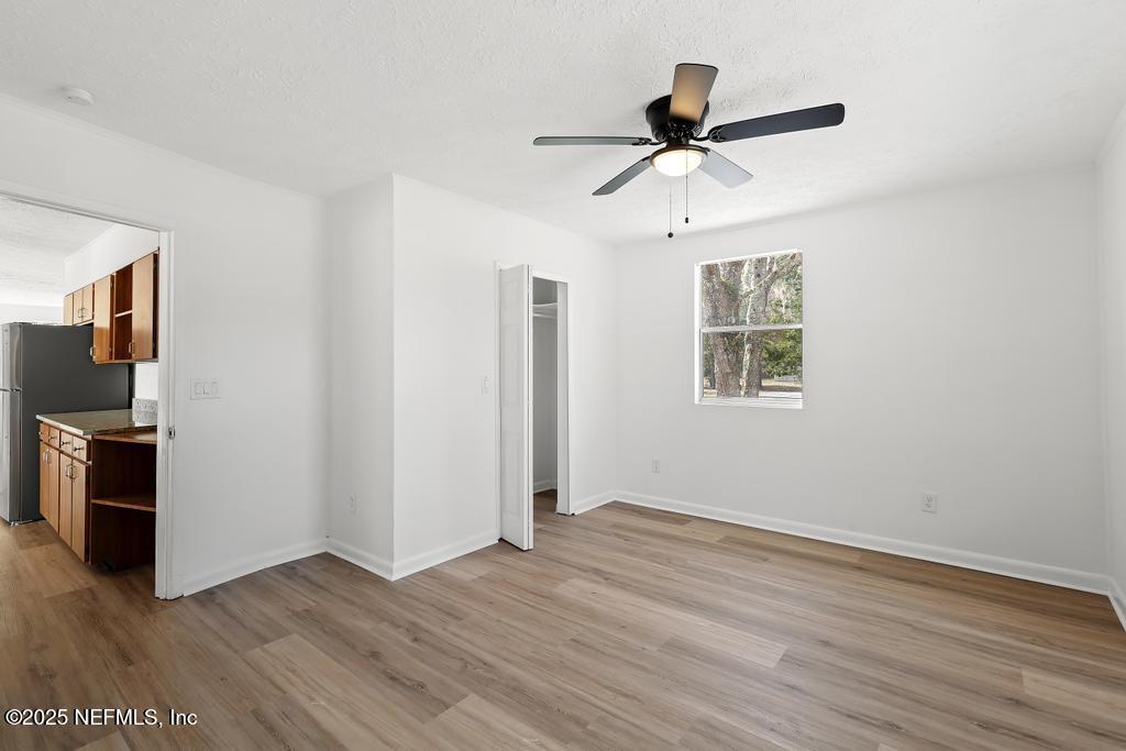54074 Charles Street Callahan, FL 32011 - Photo 36 of 52 a view of a livingroom with wooden floor and a ceiling fan