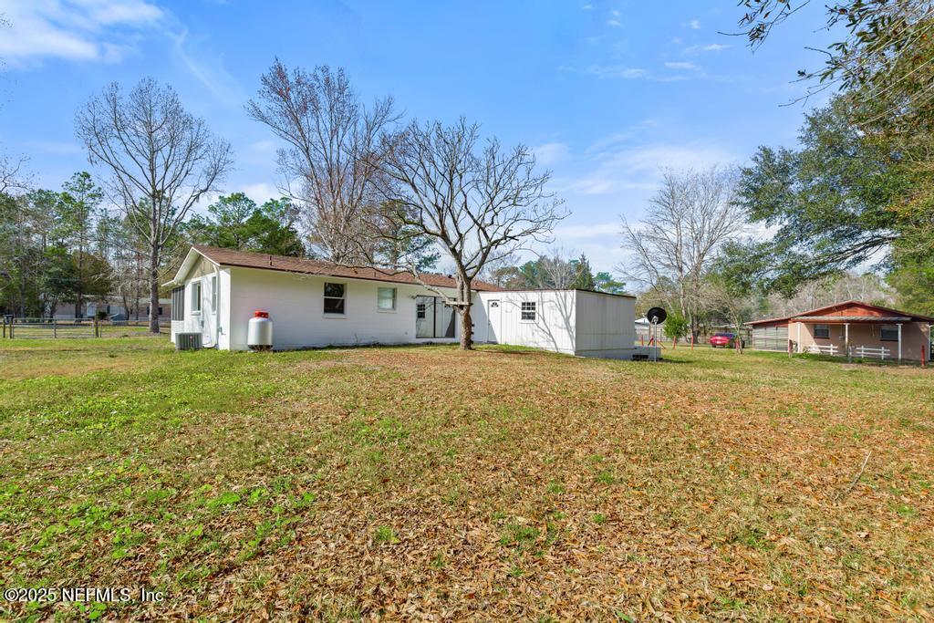 54074 Charles Street Callahan, FL 32011 - Photo 49 of 52 a front view of house with yard and trees