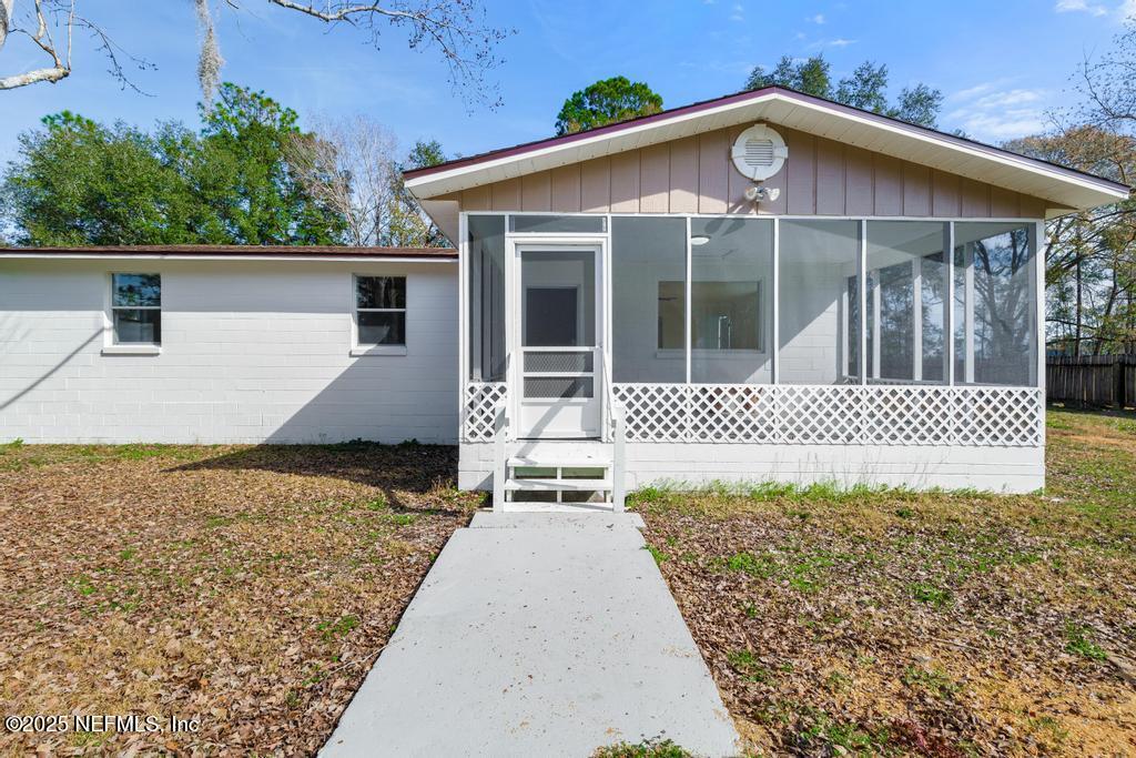 54074 Charles Street Callahan, FL 32011 - Photo 6 of 52 a front view of a house with a garden