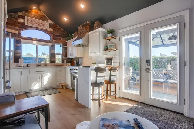 a kitchen with stainless steel appliances granite countertop a sink stove and cabinets