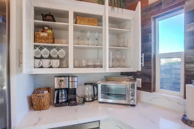 a kitchen with stainless steel appliances granite countertop a stove and a white cabinets