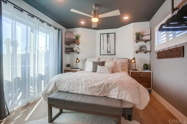 a bedroom with a bed and wooden floor