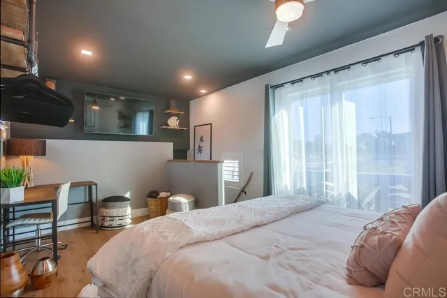 a bedroom with a bed and a lamp with window