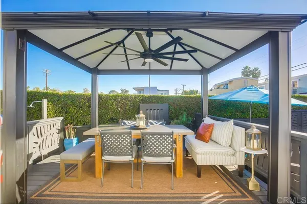a kitchen with a table chairs and wooden floor