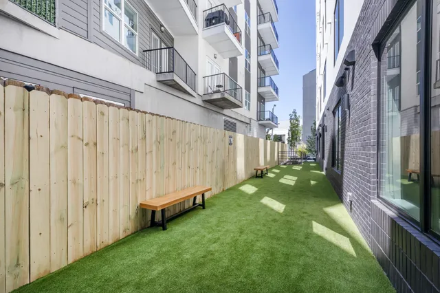 a kitchen with stainless steel appliances a dining table and chairs