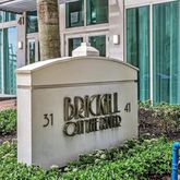 a sign board with a small yard and potted plants
