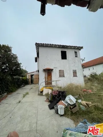 a backyard of a house with fire pit and outdoor seating
