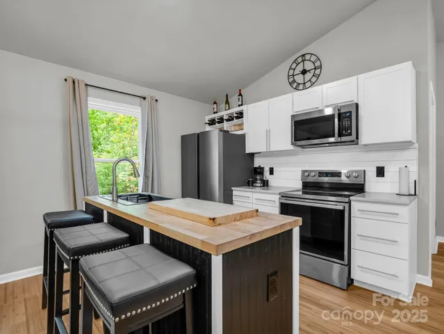 a kitchen with a stove a sink and a refrigerator