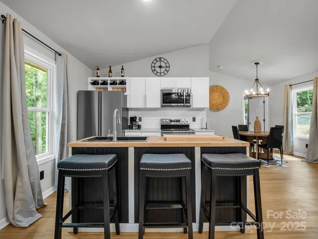a kitchen with stainless steel appliances granite countertop a stove and a refrigerator