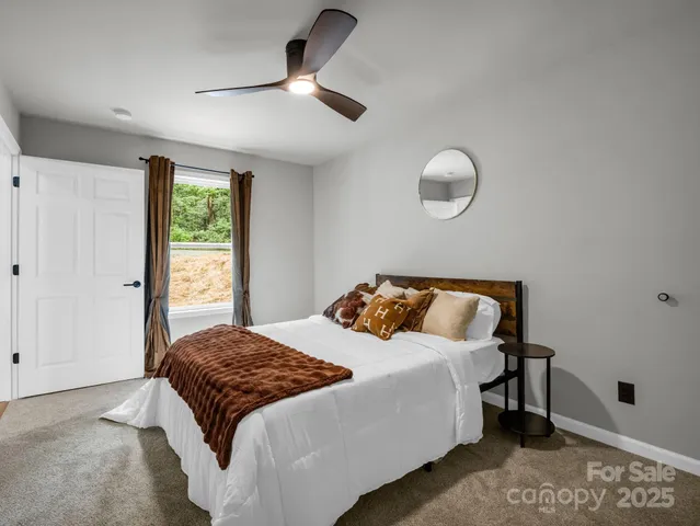 a bedroom with a large bed and a chandelier