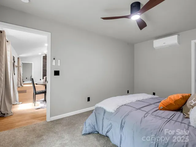 a bedroom with a bed and a view of en suite bathroom