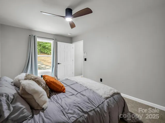 a bedroom with a large bed and a window